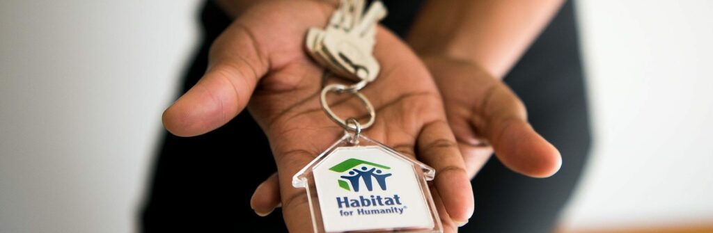 A homeowner receiving keys to their brand-new Habitat home